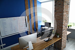 Modern empty office interior with brick wall