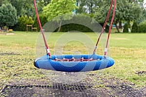 Modern empty swing on the playground