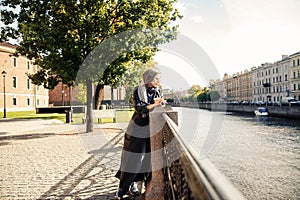 Modern energetic elderly woman   in city park
