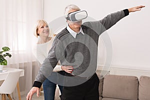 Modern entertainment. Senior man using vr goggles