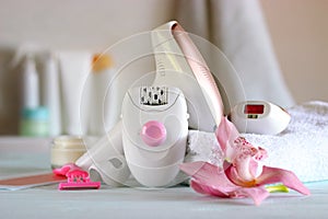 A modern epilator on the background of the bathroom interior.