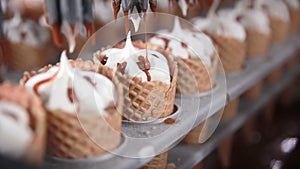 Modern equipment at the food factory. Automatic conveyer, production line of ice-cream cones.