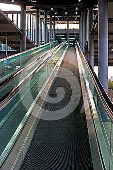 Modern escalator with a glass enclosure.
