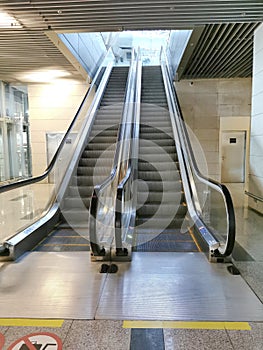 A modern escalator inside the metro, at the international airport, shopping, office center. Without people. Coronavirus