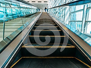 Modern escalator with staircases in metro or mall, perspective