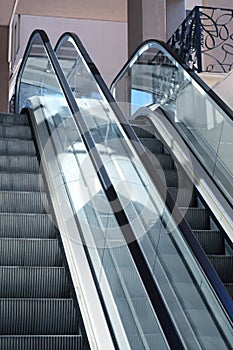 Modern escalators with handrails in shopping mall