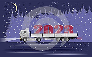 A modern European truck with a semi-trailer carries the symbol of the new year 2023 at night