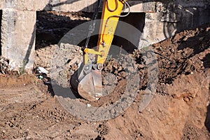 The modern excavator JCB performs excavation work on the construction site