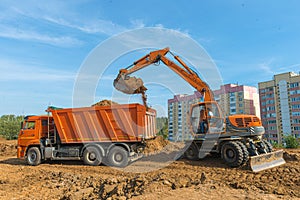 The modern excavator performs excavation work on the construction site