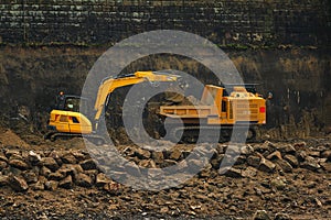 The modern excavator performs excavation work on the construction site