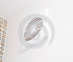 Modern exhaust fan in the bathroom to ventilate the room from unpleasant odors and humidity, close-up