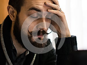 Modern, Expressive Bearded Office Clerk with Mustages Bored to Work in Office