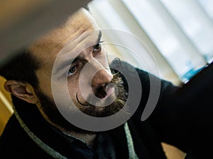 Modern, Expressive Bearded Office Clerk with Mustages Bored to Work in Office