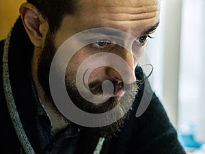 Modern, Expressive Bearded Office Clerk with Mustages Working with Notebook at Office