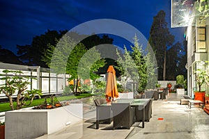 Modern exterior of luxury private house at twilight. Beautiful garden.