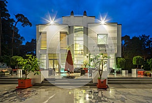 Modern exterior of luxury private house at twilight. View of entrance.