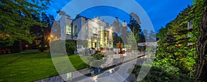 Modern exterior of luxury private house at twilight. View of entrance.