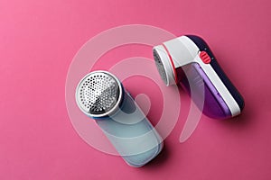 Modern fabric shavers on pink background, flat lay