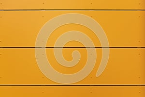 Modern facade with faÃÂ§ade cladding and thermal insulation of yellow-orange elements, riveted to a substructure