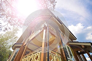 Modern facade of a wooden house on sky background