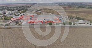 Modern factory top view, flying around a new modern factory in orange colors. Industrial exterior of a modern factory