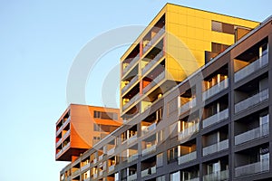 Modern family apartment building against blue sky at sunset