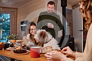 Modern Family With Dog In Wooden Cottage