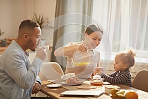 Modern Family Enjoying Breakfast in Sunlit Kitchen