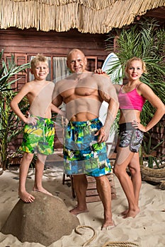 A modern family of three on a sandy beach with a