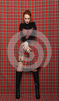 Modern fashion. A girl in a checkered dress