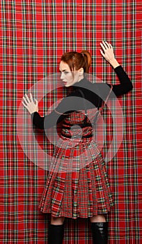 Modern fashion. A girl in a checkered dress