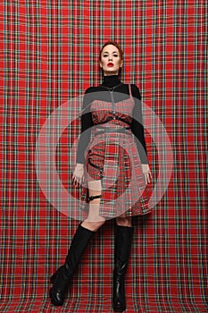 Modern fashion. A girl in a checkered dress