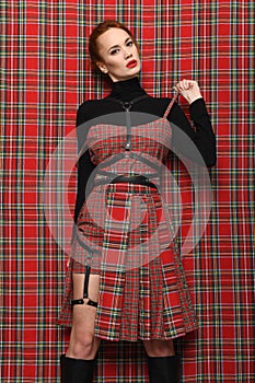 Modern fashion. A girl in a checkered dress