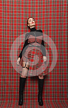 Modern fashion. A girl in a checkered dress