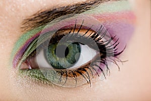 Modern fashion green violet makeup of a female eye - macro shot