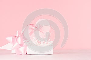 Modern fashion Valentine days background - trendy pink heart with ribbon and present on white wood board, copy space.