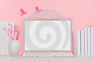 Modern fashion workplace - silver laptop with blank screen, white stationery, stickers magnet on soft pink background.