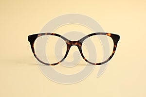 Modern fashionable acetate spectacles on yellow. photo