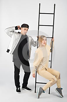 Modern fashionable hipster couple with ladder