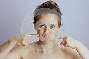 modern female checking skin firmness photo