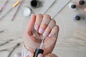 Modern female nude design manicure. Nail care, Self care. Professional Hardware Manicure. Procedure for the preparation of nails.