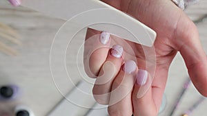 Modern female nude design manicure. Nail care, Self care. Professional Hardware Manicure. Woman makes herself a manicure