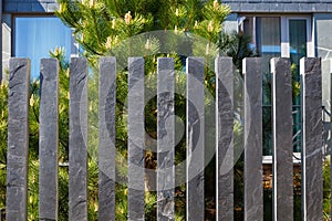 Modern fence made of bars pillars of gray, mountain, Silesian slate