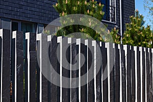 Modern fence made of bars pillars of gray, mountain, Silesian slate