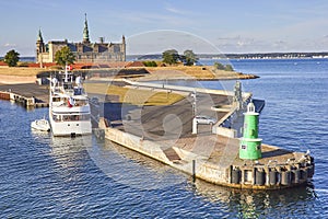 Modern ferry boat at pier, Kronborg castle at backgroung, Danmark, Europe photo