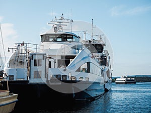 Modern ferry cruising in Oslo fjord and arriving to a city quayside