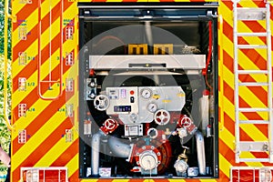 Modern fire engine. Rear view of valves with hydrants