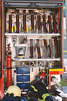 Modern fire engine. Side view. The hoses are assembled in a roll