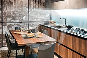 Modern fitted kitchen with table and glass wall photo