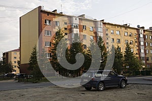 Modern five-storeyed house with flats. It was colored in red, orange and white colors